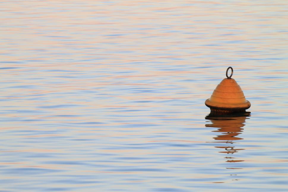 Free Image of Yellow buoy floating on calm sea 