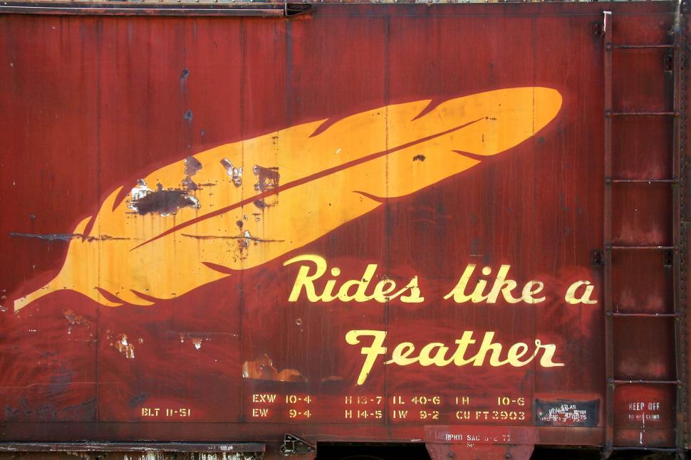 Free Image of Red Trailer With Yellow Feather Painting 