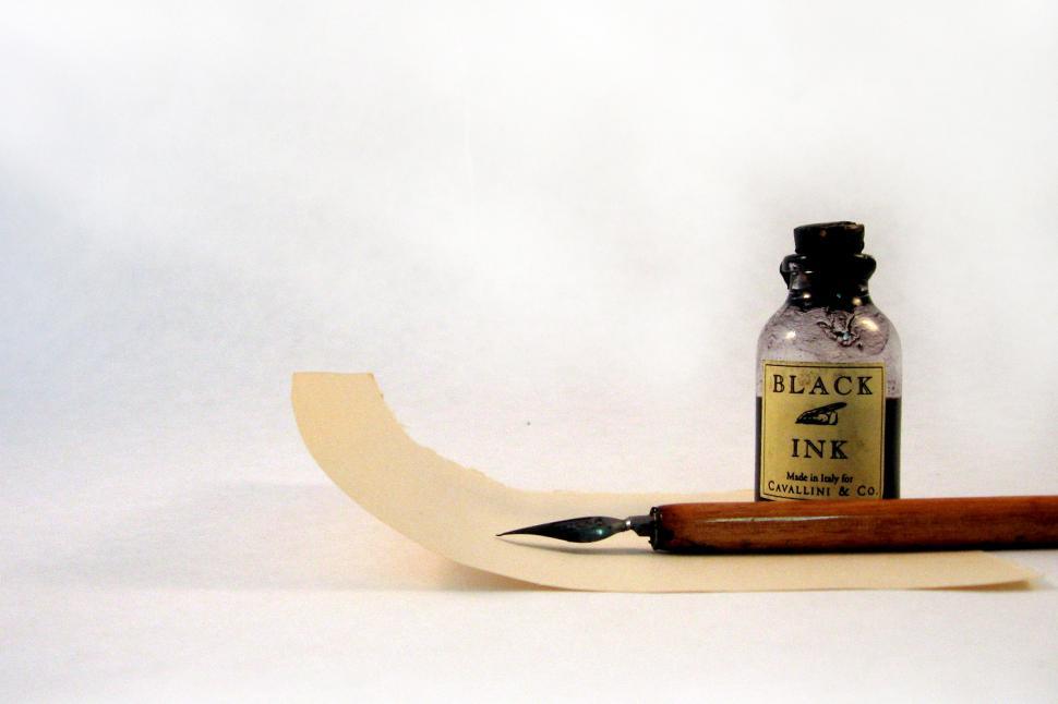 Free Image of Bottle of Ink on Piece of Paper 