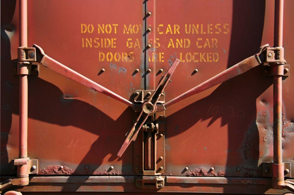 Free Image of train rivet metal texture wall dent dents door gate latch handle cargo shipping warning paint peeling peel car lock locked caution doors do not move unless inside gates and are swing pivot 
