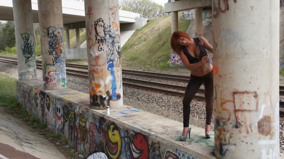 Free Image of Woman Poses with Graffiti 