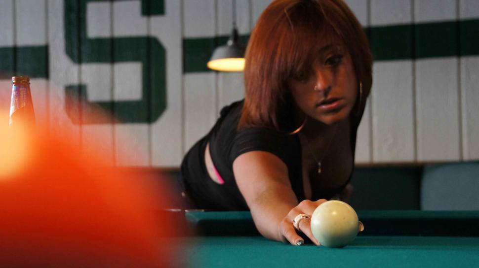 Free Image of Woman with Tattoos Playing Pool 