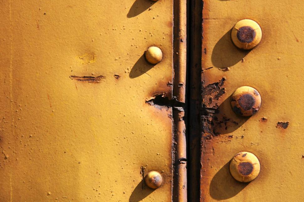 Free Image of train rust decay rivet metal texture cut damage yellow background punch hole 