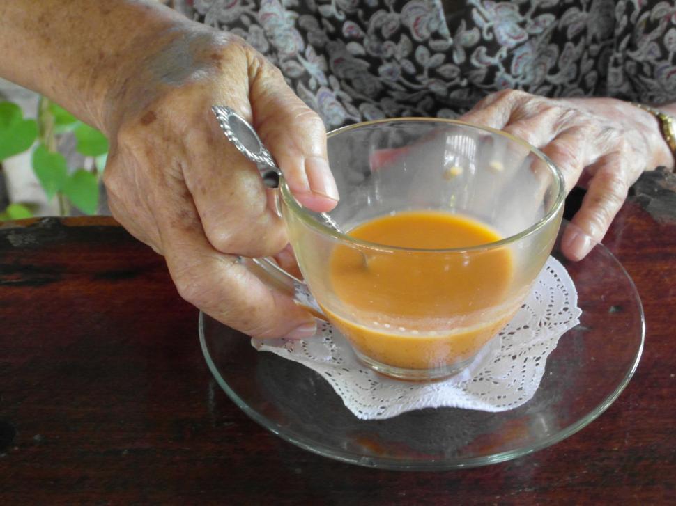 Free Image of Old Lady Holds Tea Cup 