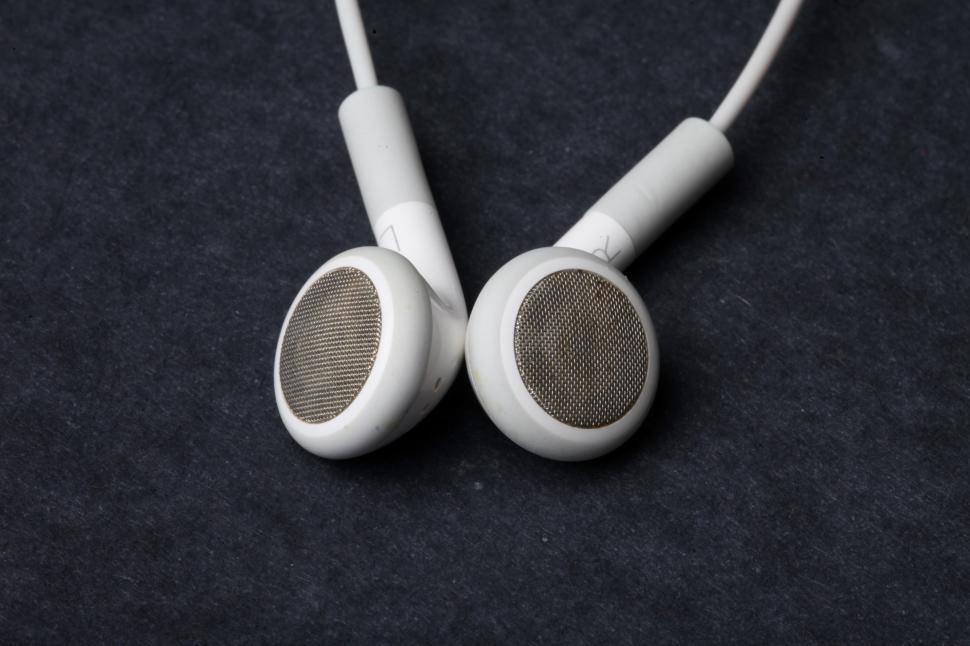 Free Image of White earphones on black background 