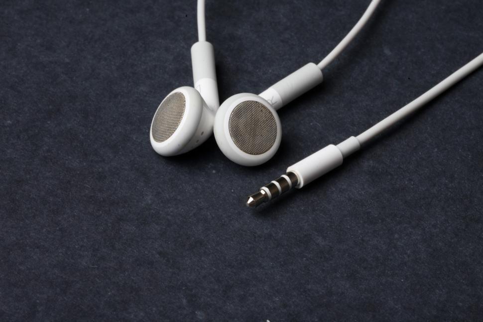 Free Image of White earphones on black background 