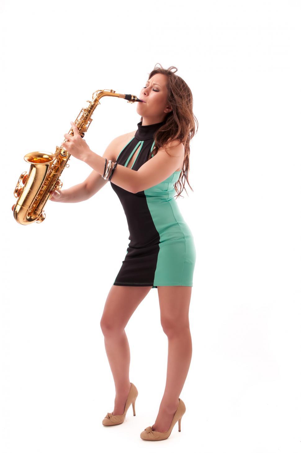 Free Image of Young woman playing the saxophone 