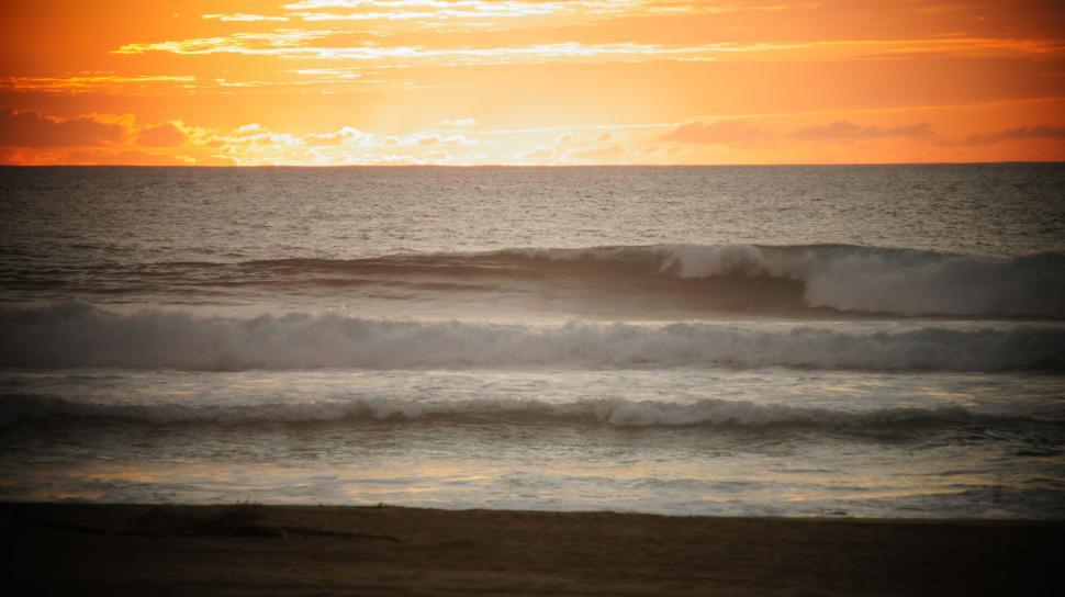 Free Image of Waves in the sunset.  