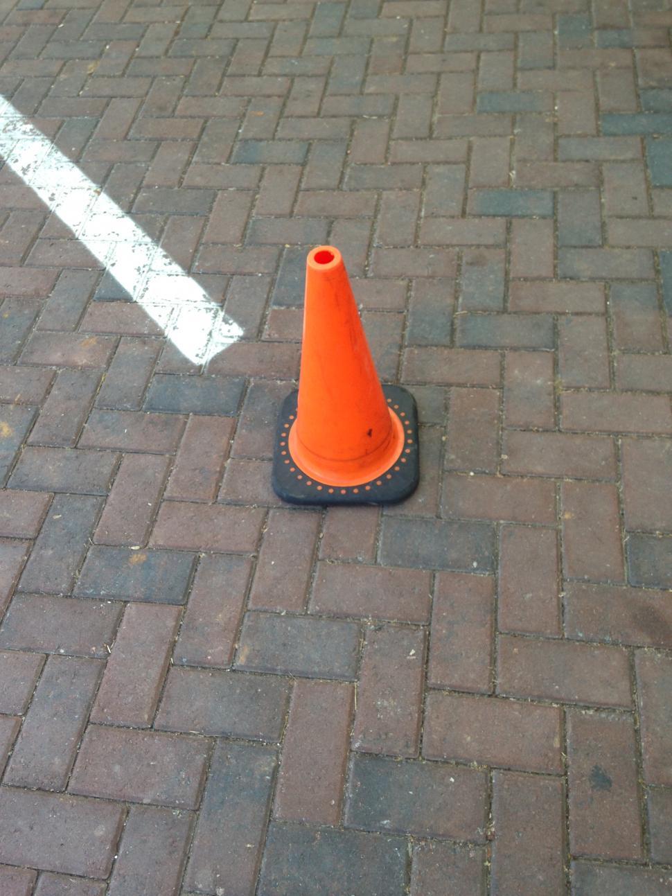 Free Image of Orange traffic cone marking space. 