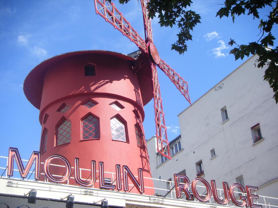 Free Image of Large Red Building With Sign on Top 