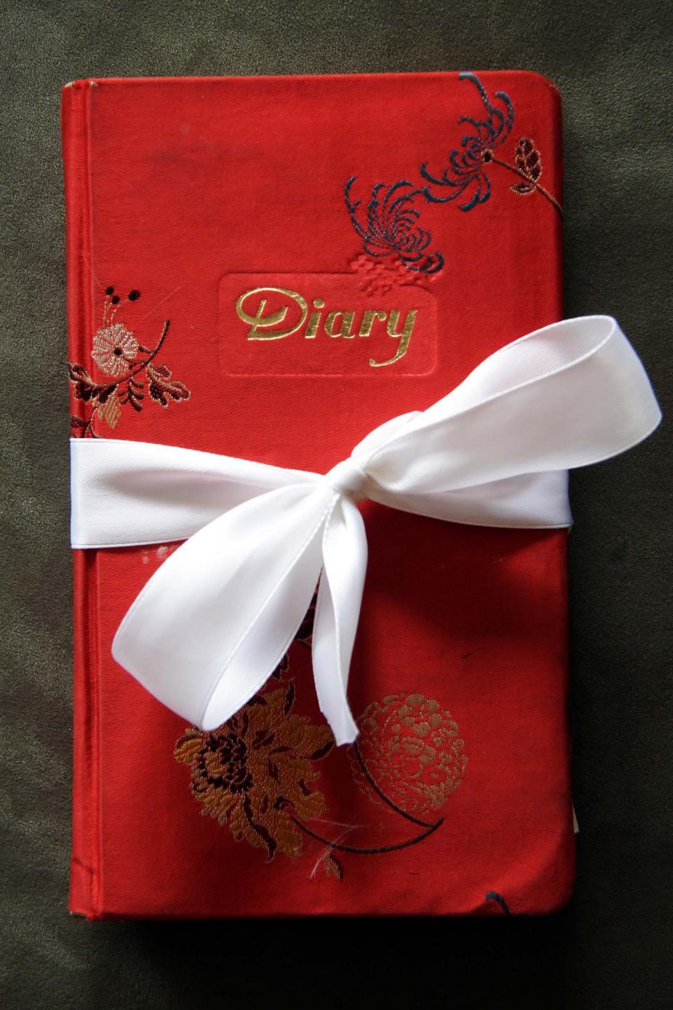 Free Image of Red Diary Book with White Bow 