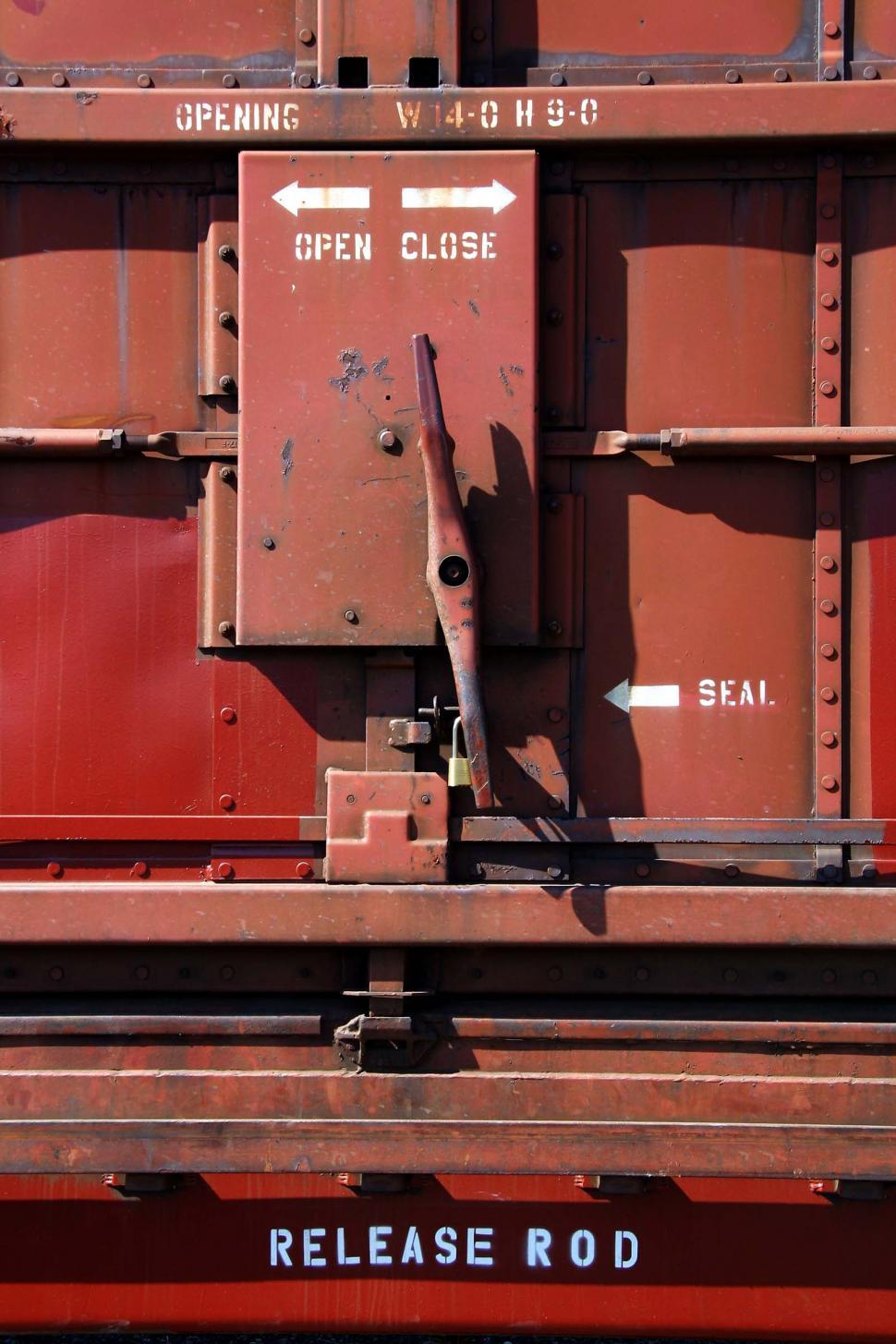 Free Image of train rivet word metal words release rod handle red open close opening lock padlock door 