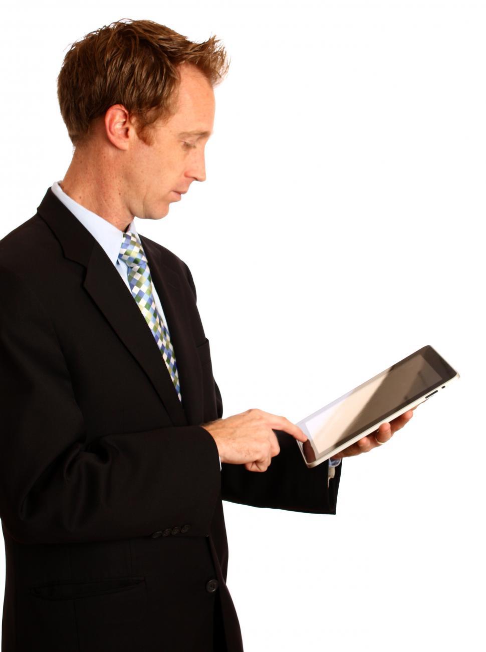 Free Image of A young businessman holding a tablet computer 