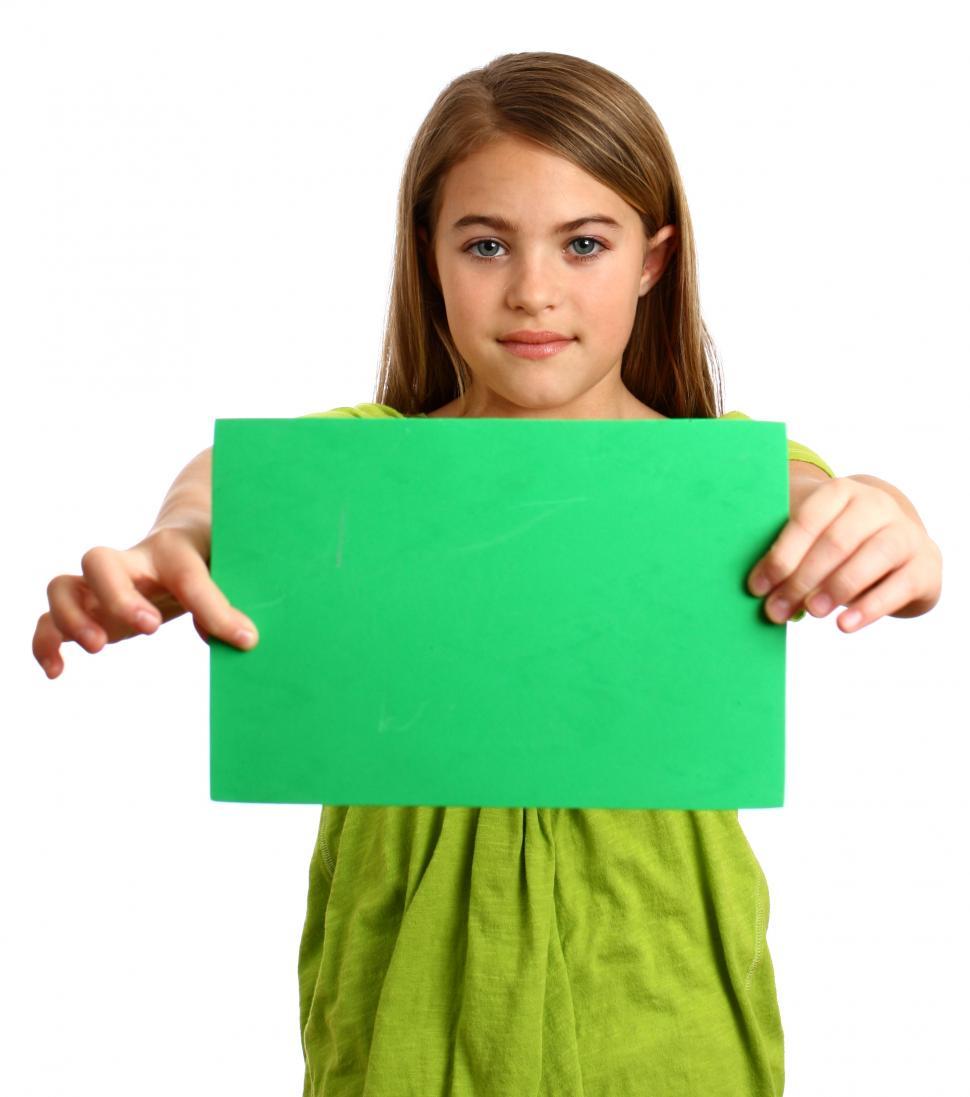 Free Image of A beautiful young girl holding a blank green sign 