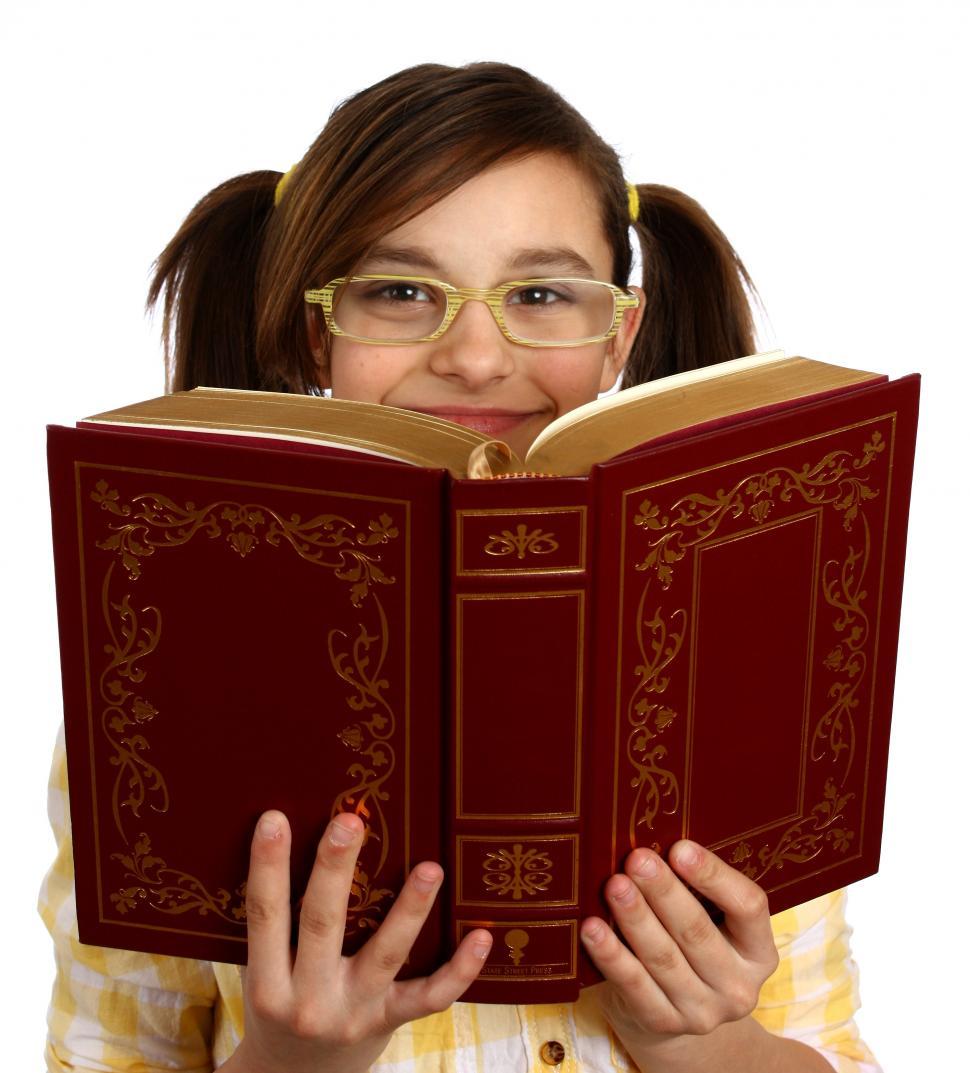Free Image of A smart girl with glasses reading a book 
