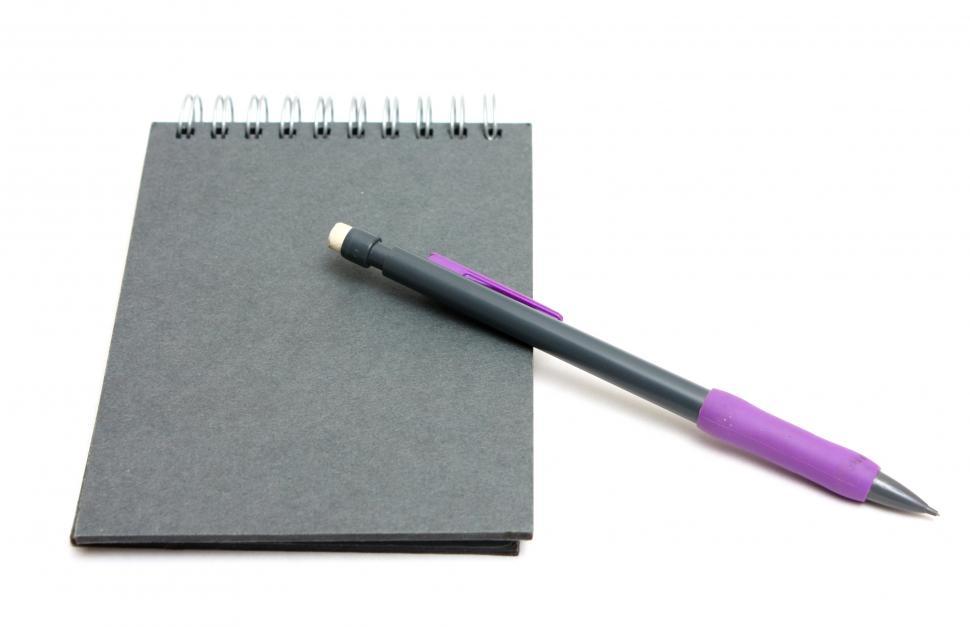 Free Image of A pad of paper and a pencil isolated on a white background 