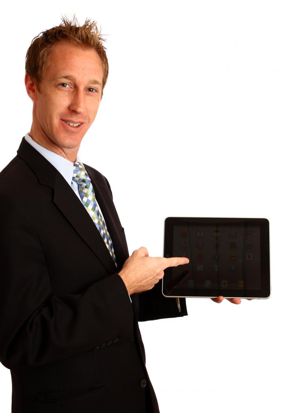 Download Free Stock Photo of A young businessman holding a tablet computer 
