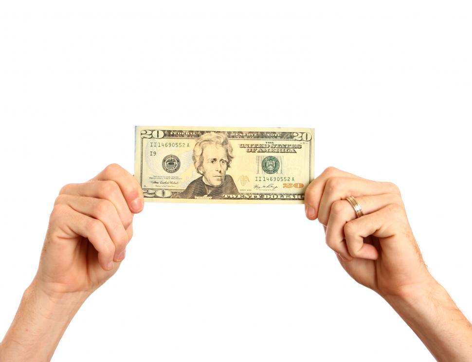 Free Image of Hands holding up a twenty dollar bill 