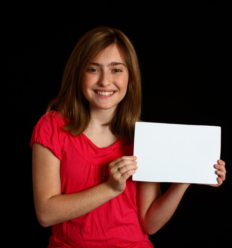Free Image of A cute young girl holding a blank sign 