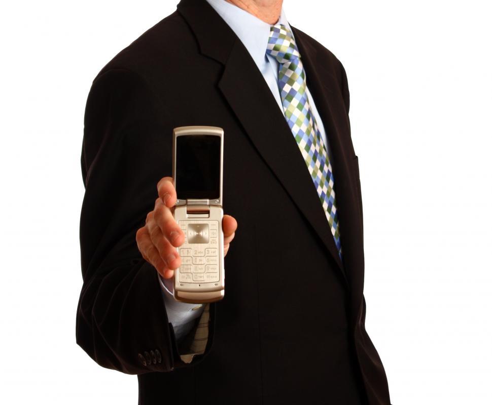 Free Image of A young businessman holding a cell phone 