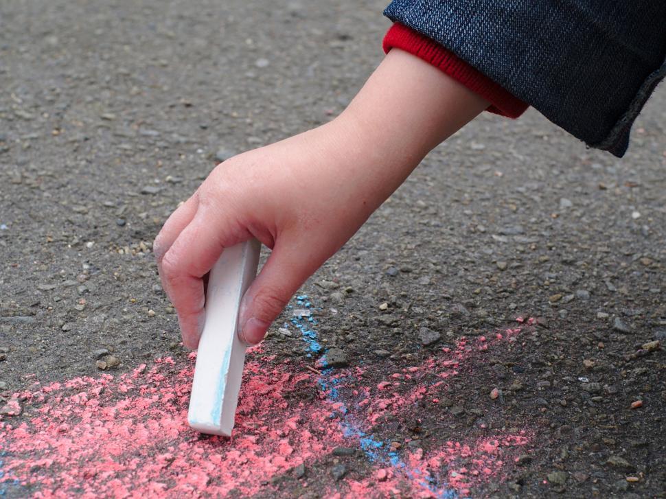 Free Image of Child drawing with sidewalk chalk 