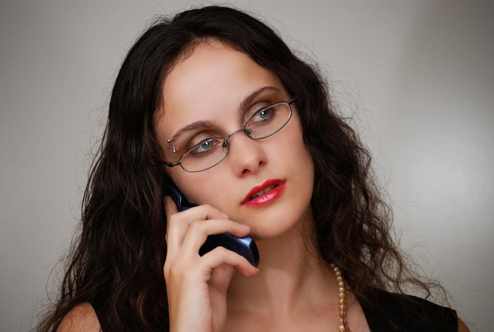 Free Image of A beautiful business woman talking on a cell phone 