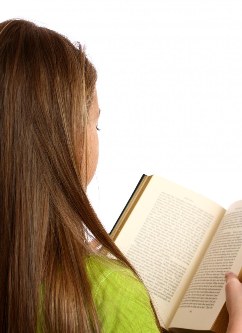 Free Image of A beautiful young girl reading a book 