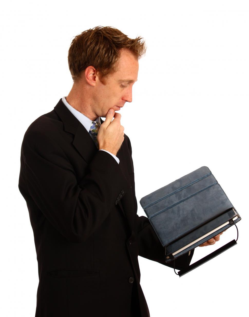 Free Image of A young businessman holding a tablet computer 