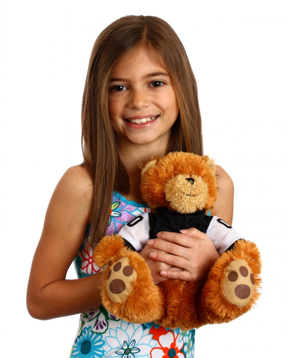 Free Image of A pretty young girl holding a teddy bear 