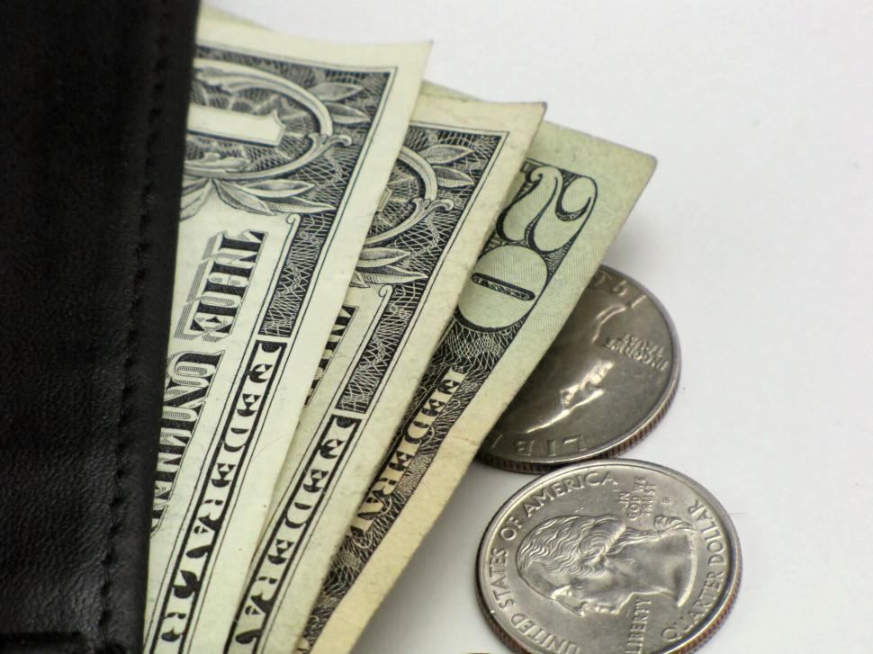 Free Image of Close-up of dollars and quarters in a wallet 
