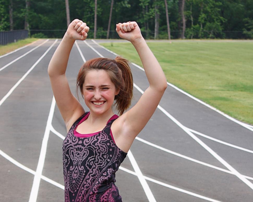 Free Image of A cute young girl on a track field 