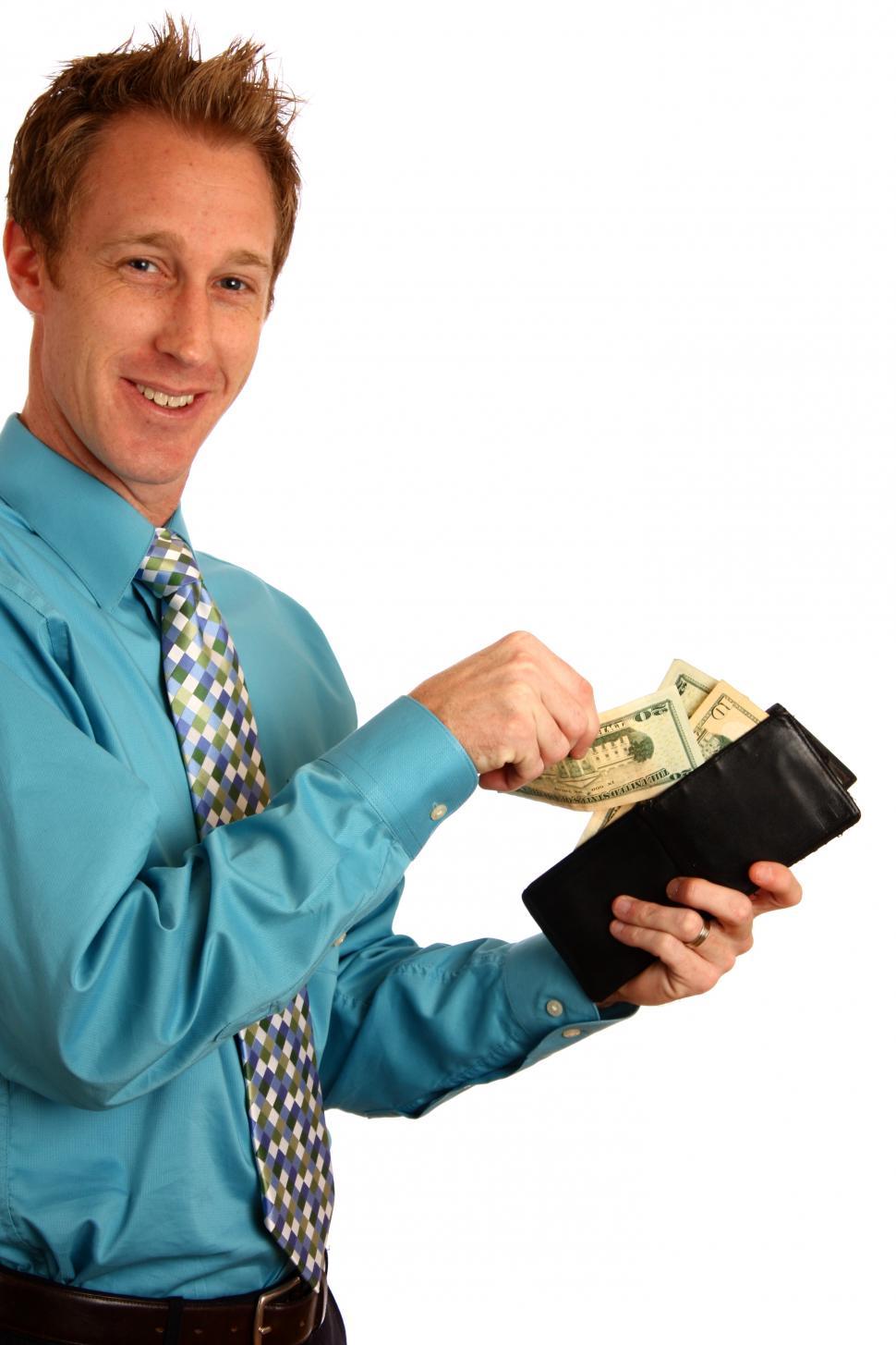 Free Image of A young businessman holding a wallet with money 