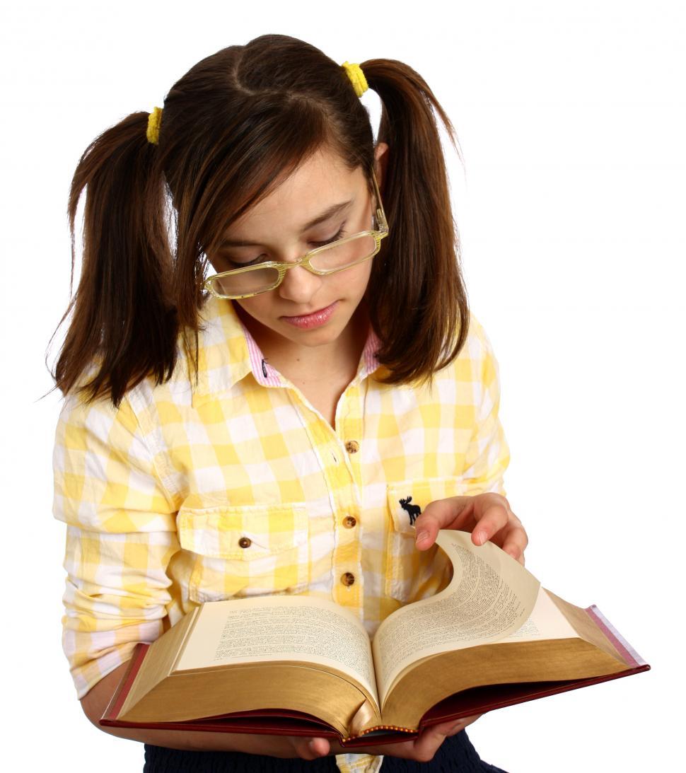 Free Image of A smart girl with glasses reading a book 