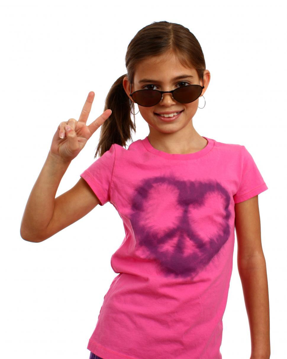 Free Image of A cute young girl making a peace symbol 