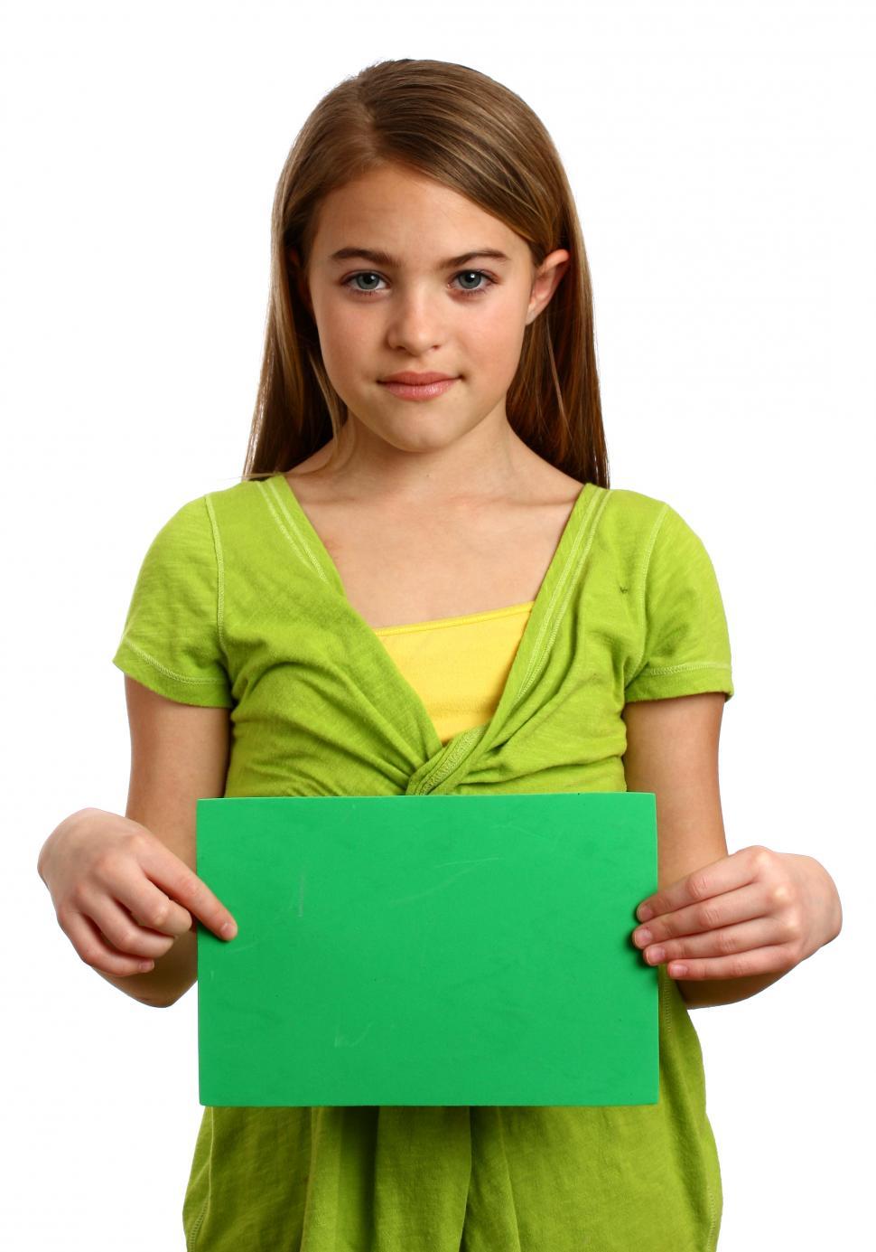 Free Image of A beautiful young girl holding a blank green sign 