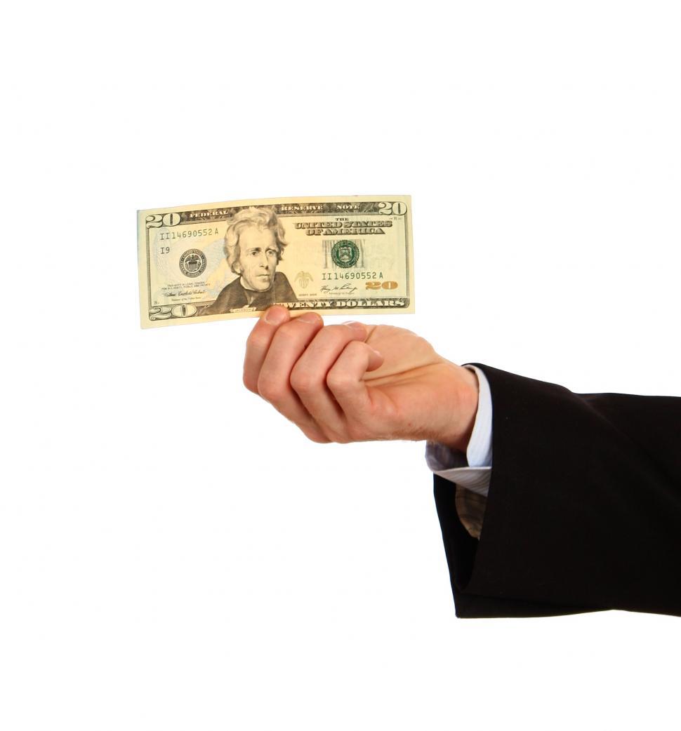 Free Image of A hand holding a twenty dollar bill 