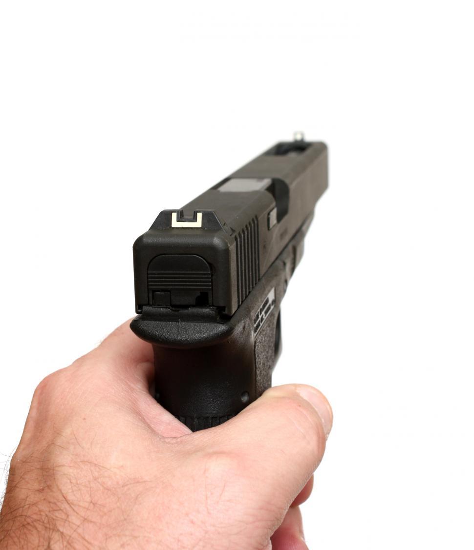 Free Image of A hand holding and aiming a pistol 