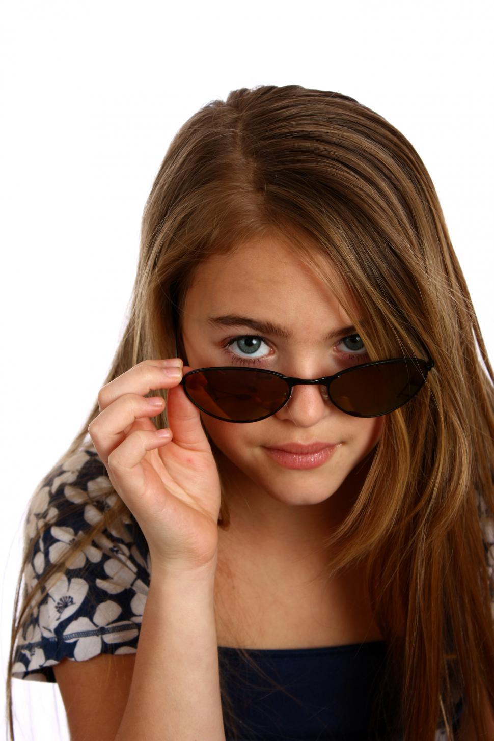 Free Image of A beautiful young girl posing with sunglasses 