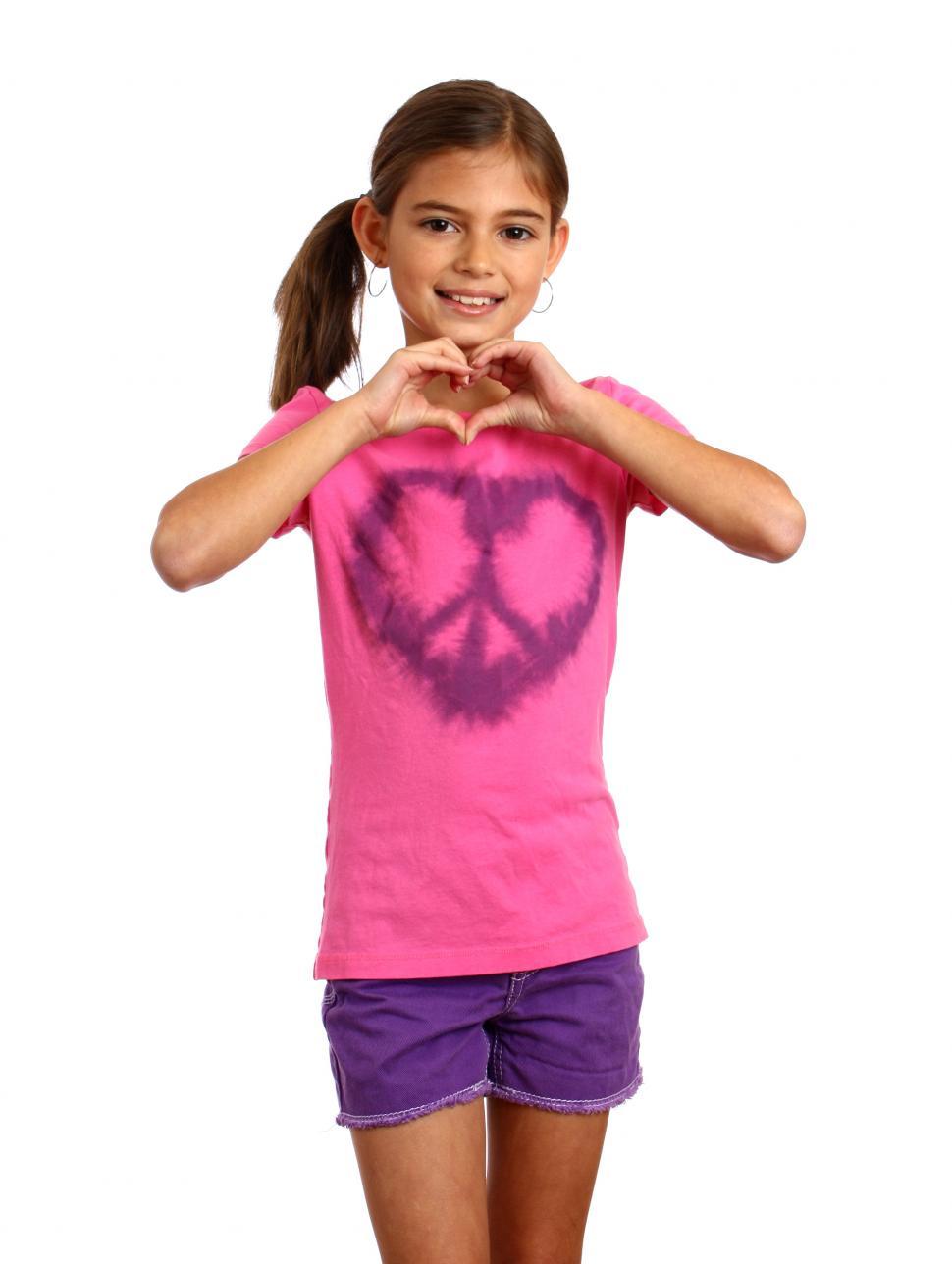 Free Image of A cute young girl making a heart symbol 