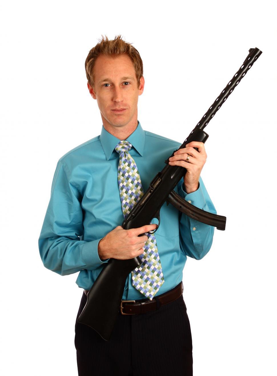 Free Image of A young businessman holding a rifle 