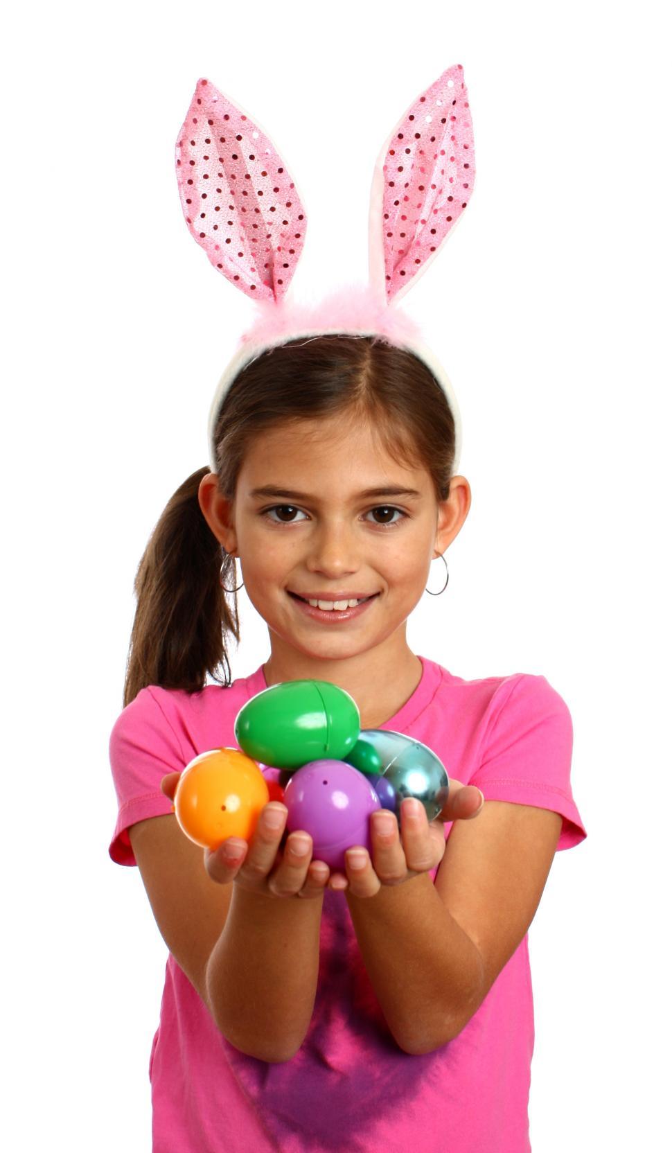 Free Image of A cute young girl holding Easter eggs 
