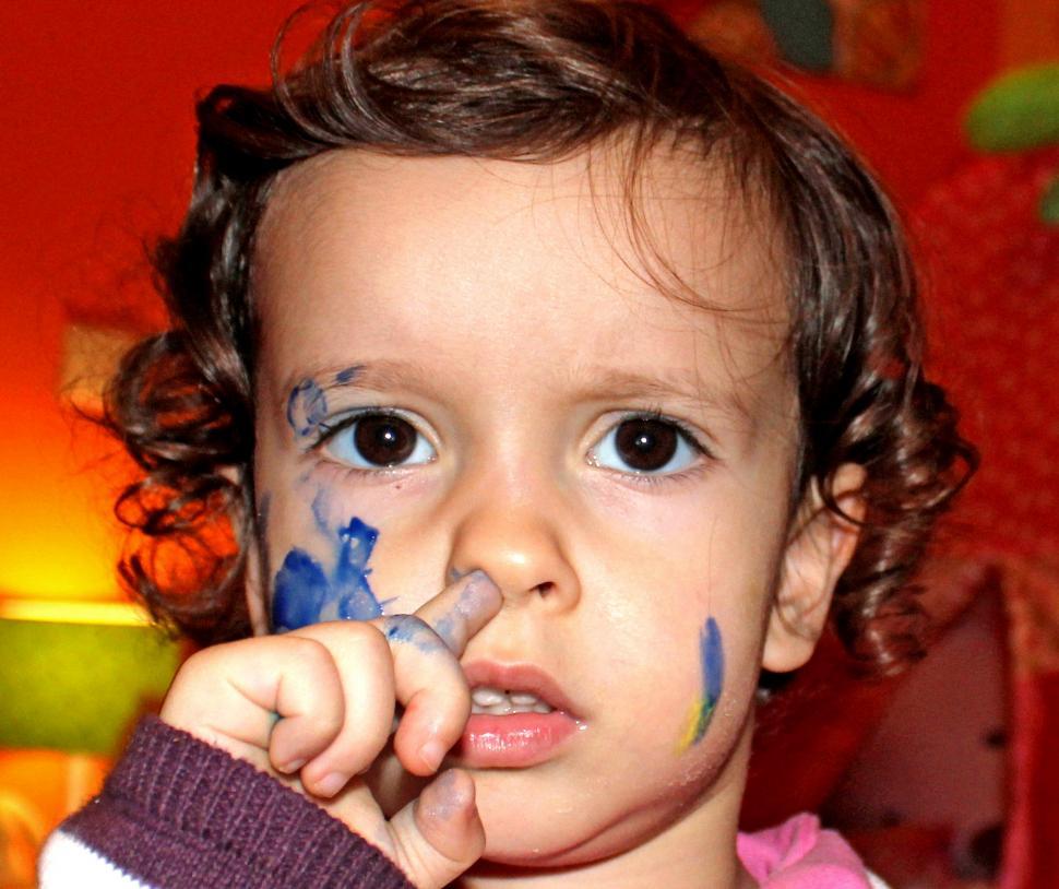 Free Image of Little Girl With Blue Paint on Her Face 