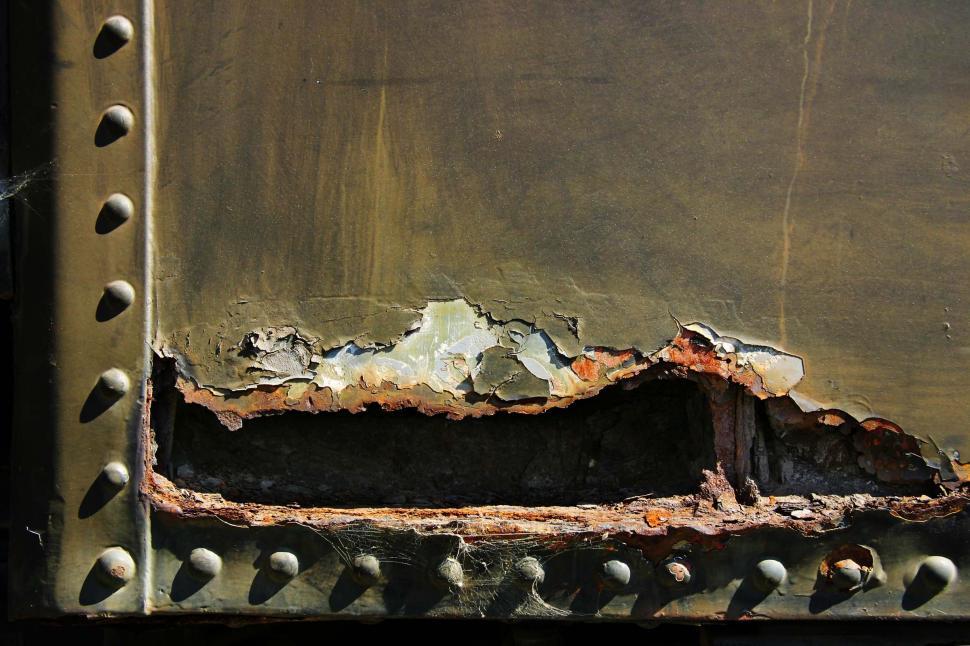 Free Image of train rust decay rivet metal scrap texture hole corrode rot corrosion decompose peel peeling paint 