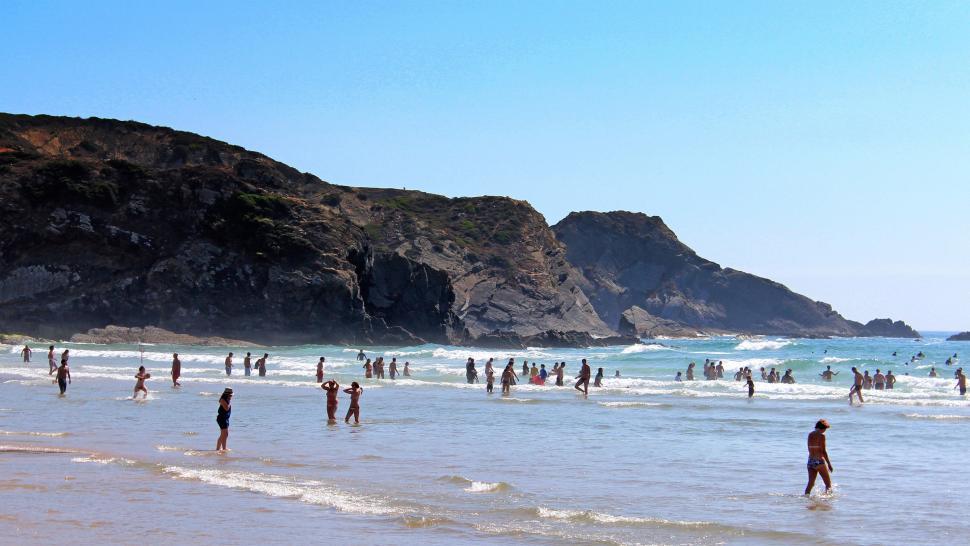 Free Image of People bathing in the ocean along Odeceixe Beach in Algarve, sou 