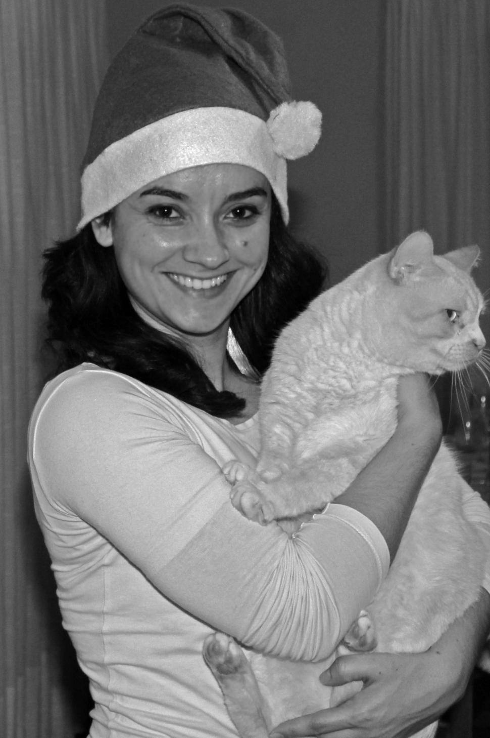 Free Image of Pretty smiling woman adopts a cat during Christmas 