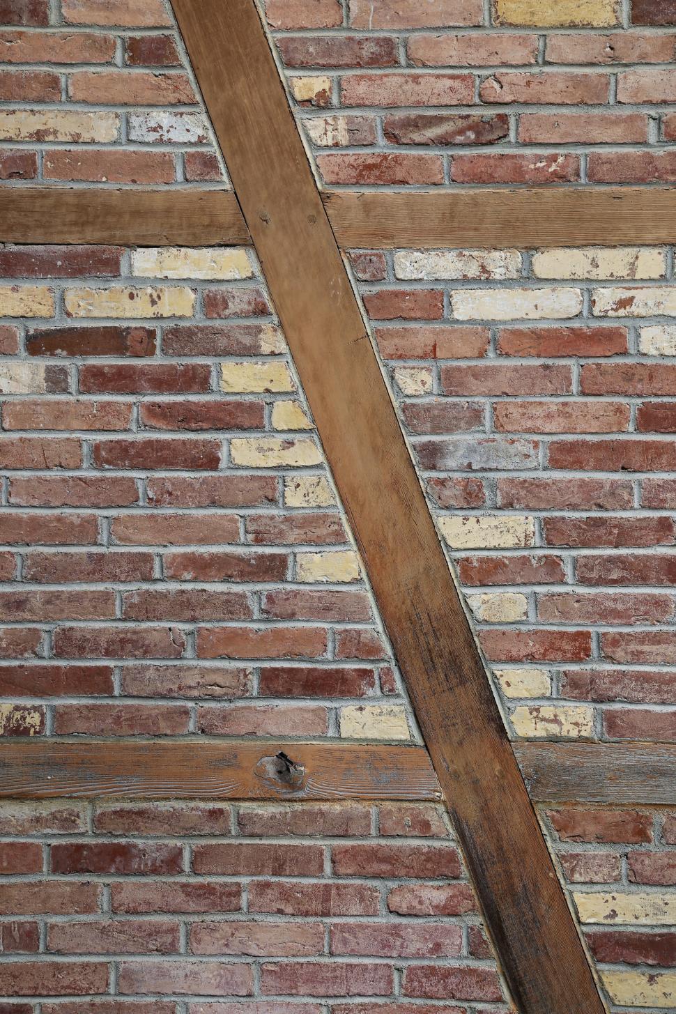 Free Image of Wood beams in brick wall 