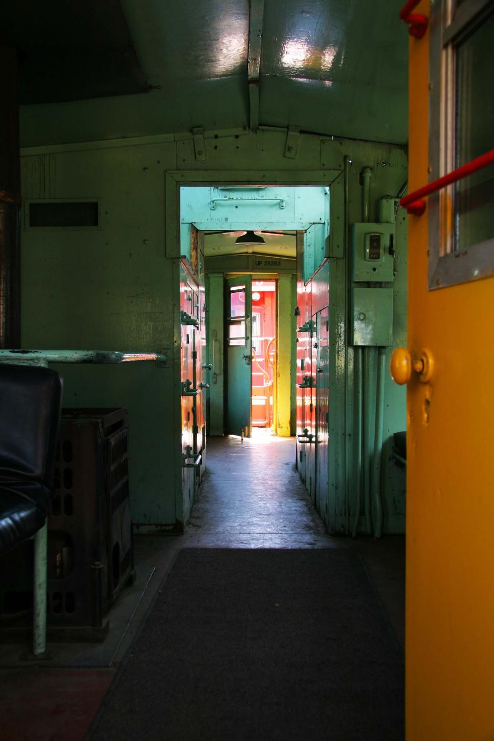 Free Image of A Hallway With a Yellow Door and a Black Chair 