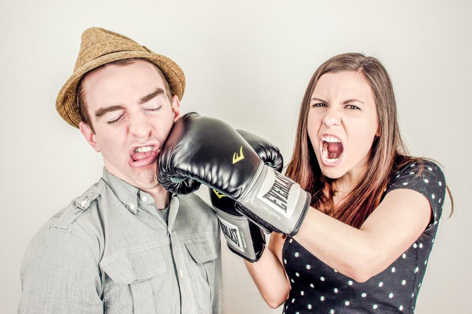 Free Image of Woman punches a man  