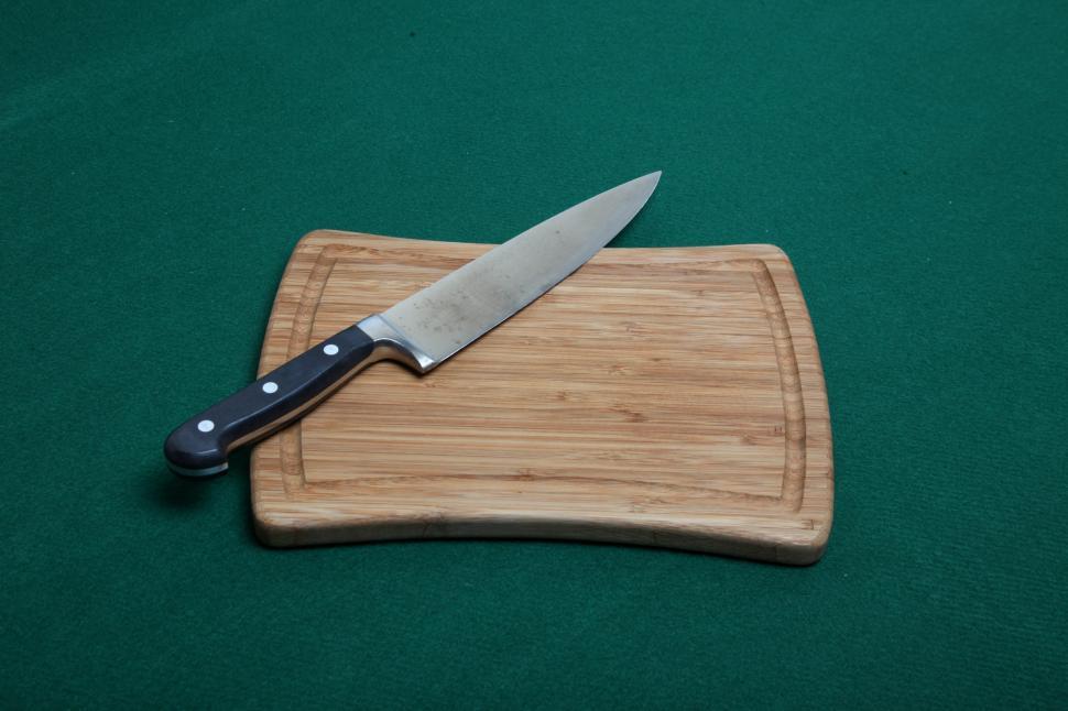 Free Image of Knife on a wooden cutting board 