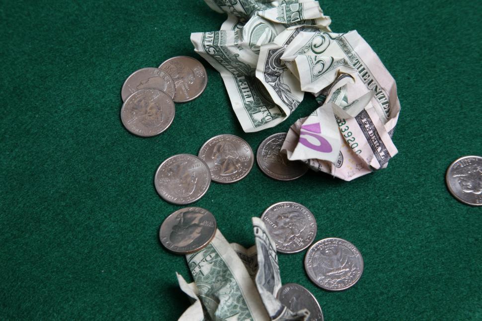 Free Image of Wad of cash and scattered coins 